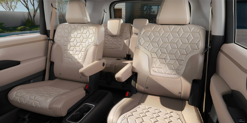 Interior of a 2025 Nissan Armada showing beige, hexagon-patterned seats and spacious seating arrangement.